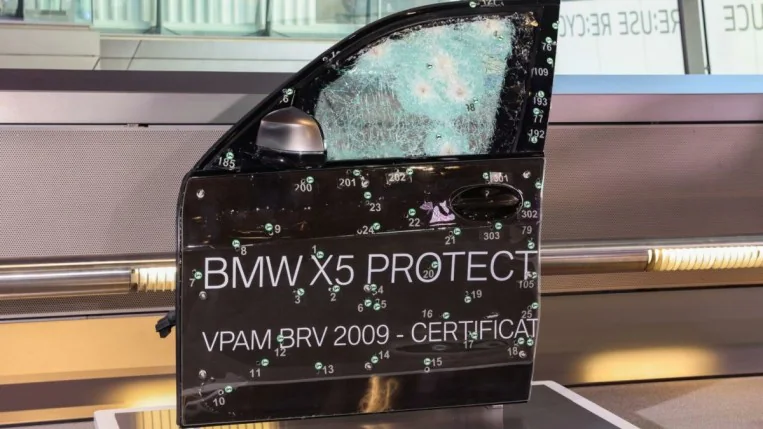 The door of an earlier BMW protection series car after testing its bulletproofing. The door is damaged but no bullets have passed through.