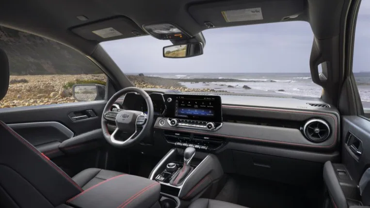 The interior of the 2023 Chevy Colorado. It has a minimalist look, with a big central touchscreen housed in the same bezel as the driver's instruments.