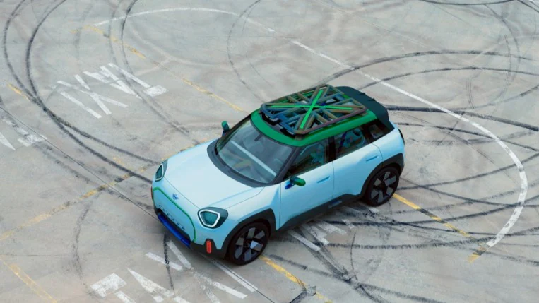 The Mini Paceman concept is parked on a concrete pad covered in tire marks. We see it from overhead, showing its roof rack modeled after the U.K. flag