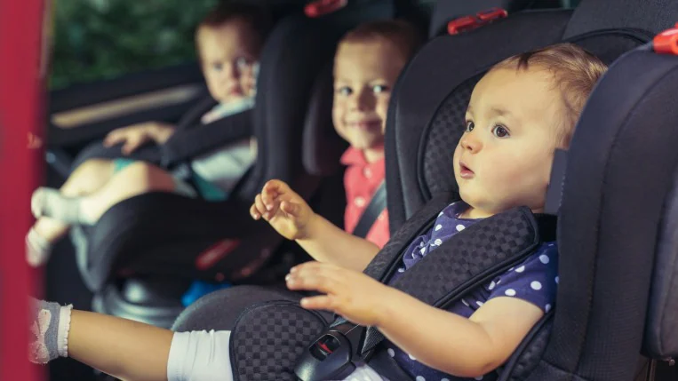 Three Children In Car Safety Seat