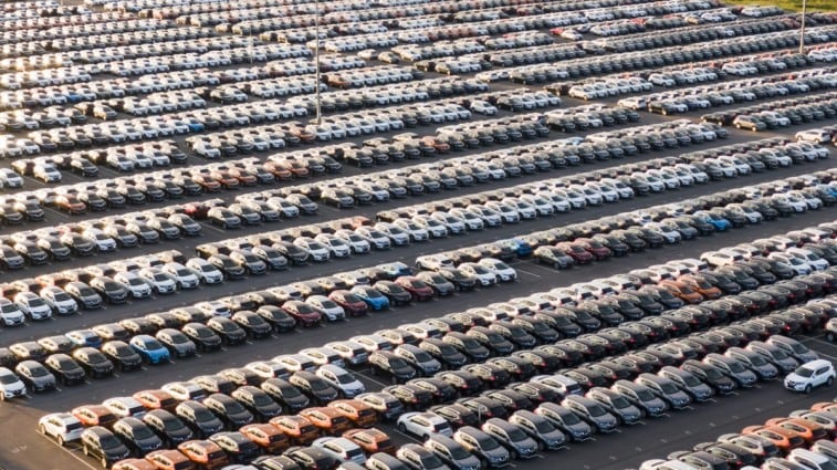 A crowded lot full of new cars awaiting shipment to dealerships