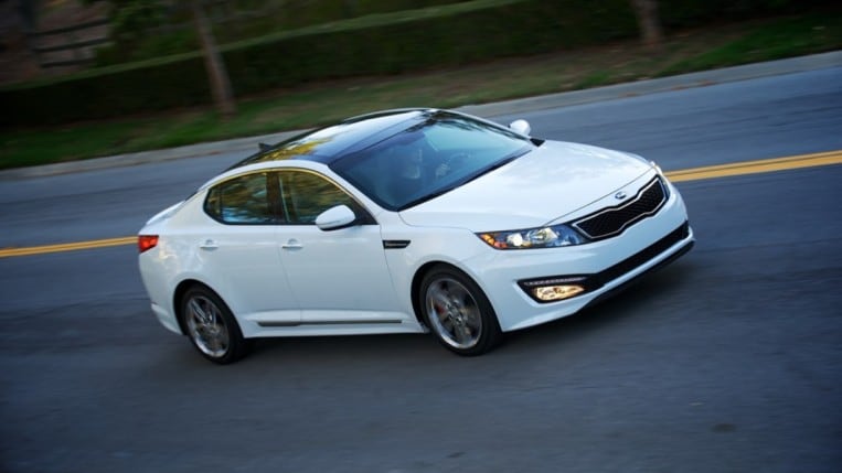 The 2013 Kia Optima in white, seen from an overhead front quarter angle