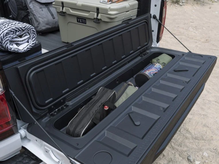 A storage bin built into the tailgate of the 2023 GMC Canyon