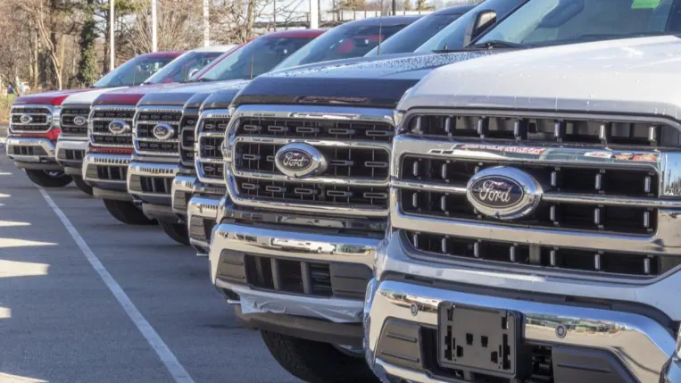 A line of Ford heavy duty trucks at a dealership